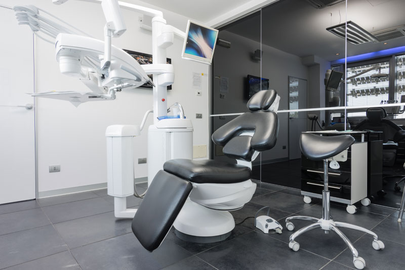 dental exam chair with technology in room