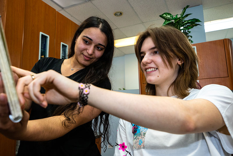 braces patient smiling and learning about treatment